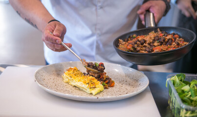 serving dishes on a plate in a professional kitchen close up