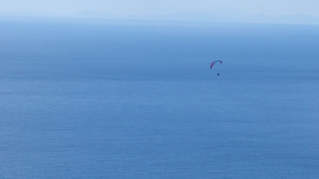 paragliders in blue sky with white clouds enjoying the sports of freedom para gliders