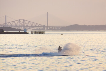 Man travelling a jet ski on the Firth of Forth 