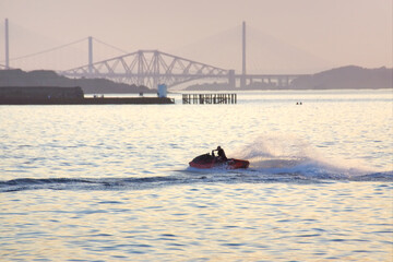 Man travelling a jet ski on the Firth of Forth 