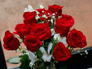 Red Roses, Babys Breath and White Geranium Flowers in a Window