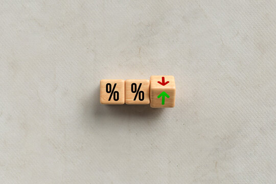 cubes with percent signs and up and down arrow on paper background