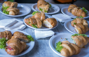 croissants with filling are served on white plates