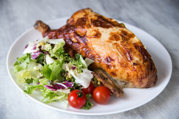 stuffed chicken baked in the oven served on a plate with salad