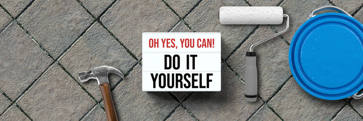 lightbox with message OH YES, YOU CAN! DO IT YOURSELF and handyman tools on stone background