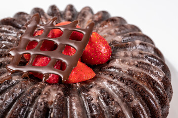 bundt cake chocolate with strawberries and strawberry icing