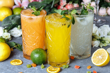 Summer fresh cold drink beverages. Ice Lemonade in the jug and lemons and orange with mint on the...