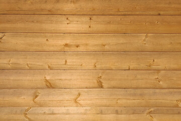 Texture of the wooden wall of the house from a large horizontal blockhouse. Eco-friendly facade cladding.