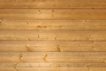 Obraz premium Texture of the wooden wall of the house from a large horizontal blockhouse. Eco-friendly facade cladding.