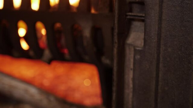 Opening stove door glowing fire and closing