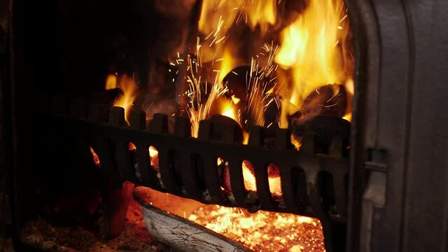 Opening stove and stoking coals
