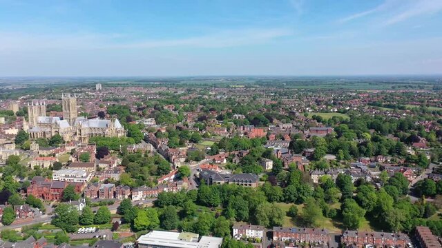 Aerial footage of the Lincoln Cathedral, Lincoln Minster in the UK city centre of Lincoln East Midlands on a bright sunny summers day showing the historic Cathedral Church in the British city centre