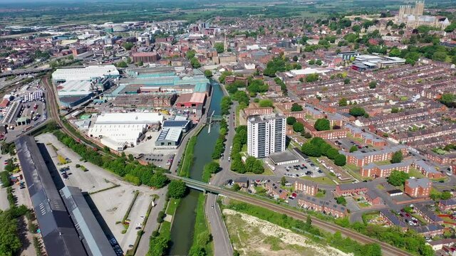 Aerial footage of the city centre of Lincoln on a bright sunny summers day the city is in the English East Midlands showing the canal with the Lincoln Cathedral, Lincoln Minster in the background