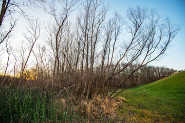 sun setting on a winter landscape below a spillway