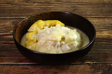 Durian sticky rice in coconut milk and durian creamy sauce. One of most famous Thai dessert in summer of durian season. Selective focus