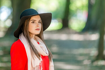 Pretty girl thinking looking far away while waiting for date in the city park.