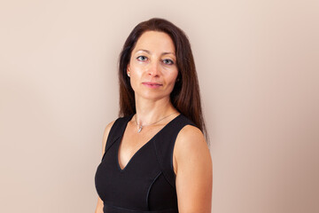 pretty women with long hair in black dress studio portrait.