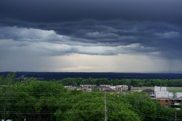 A dark storm front moves in over a city
