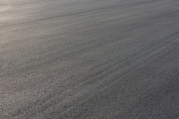 Sun reflection on new asphalt road background