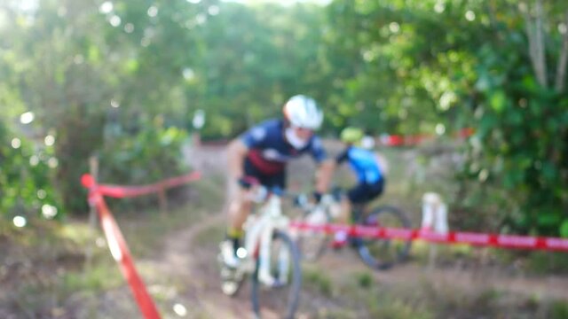 blur defocus of cyclist ride mountain bike in forest for healthy and leisure at day time