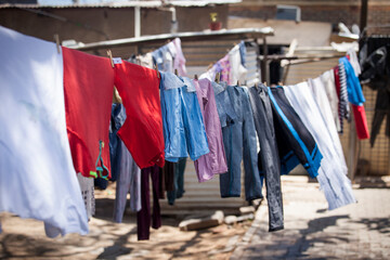 Laundry hangs to dry on outdoor clothes lines in a township in South Africa.