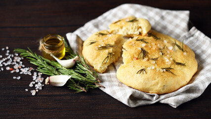 Fresh homemade focaccia with salt and rosemary. Traditional italian bread.