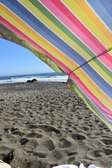 Bright colorful beach umbrella happy day at ocean 