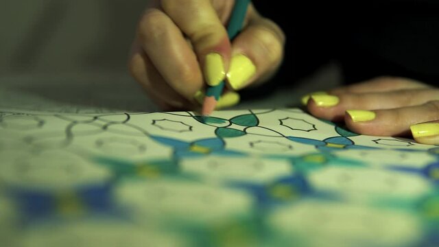 crayons and pattern painting by a woman's hands