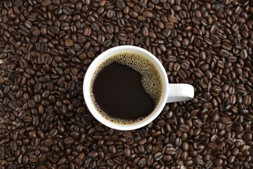 cup of coffee with coffee beans background