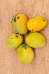 Ripe Green Skin Mangoes On Wooden Background