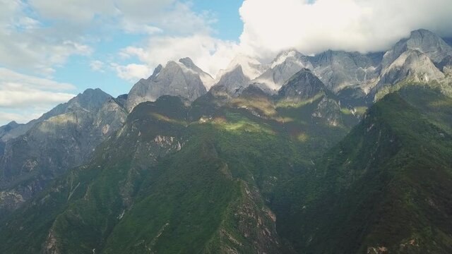 A drone shot from scenic checkpoint of Tiger Leaping Gorge trekking route showing Jad Dragon Snow Mountain ahead.