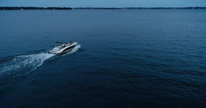 Speed boating at sunset, aerial drone shot, Lake Norman, NC