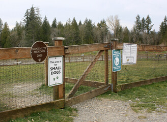 Signs displayed at the entrance of the local dog park.