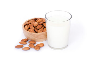 Glass of Almond milk and almond seeds in wooden bowl isolated on white background. Healthy drinks concept. 