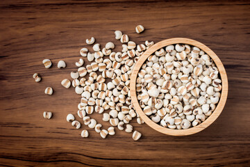 Job's tears ( adlay, millet ) in bowl on wooden background