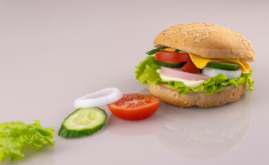 making sandwiches for breakfast. delicious burger on a glass surface with reflection.