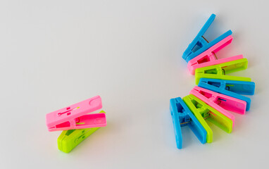 The multi-colored clothespins on a white background.