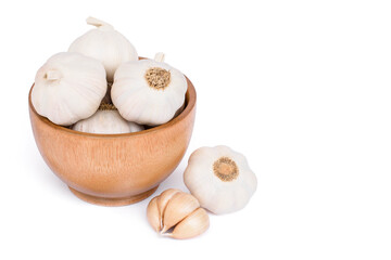 Garlic head or bulb in wooden bowl isolated on white background.