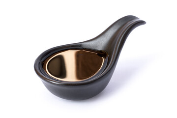 Tasty soy sauce in black ceramic bowl isolated on white background with clipping path. 