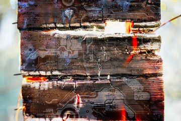 Burning log with silhouette of the computer motherboard. Circuit board. Electronic computer hardware technology. Concept for advertisement banner.