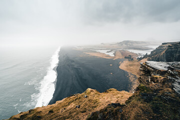 Moody Black Sand Beach in Iceland during the rainy and foggy weather reflects the typical weather conditions of north countries