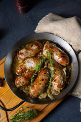 Homemade white sausage fried with onion and herbs