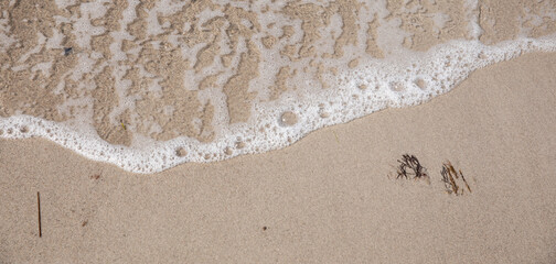 Fototapeta na wymiar Sand with water on the beach
