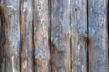 Wooden unpainted boards texture or background. Wall of a wooden house.