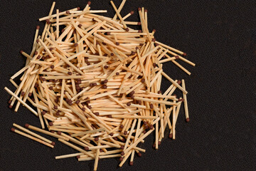 A figure made of matches on a black background