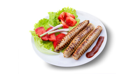 grilled sausages on a plate with vegetables