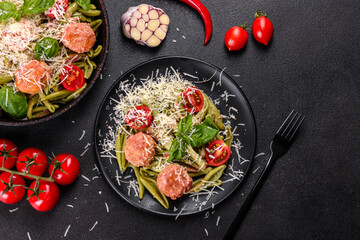 Delicious fresh pasta with meatballs, sauce, cherry tomatoes and basil