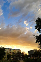 thunderclouds clouds and sunlight on the background of the building