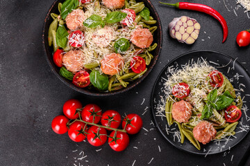 Delicious fresh pasta with meatballs, sauce, cherry tomatoes and basil