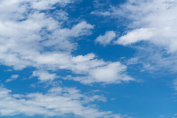 Naklejka na ściany i meble Beautiful blue sky with white cloud. Fluffy clouds moving in the wind on the blue sky.